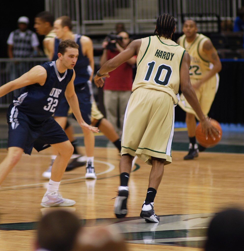 a man sitting on the ground painting a wall